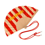 Close-up view of the opened red striped wooden fan, showcasing the fabric texture, contrast yellow lettering, and attached red contrast shoulder strap.