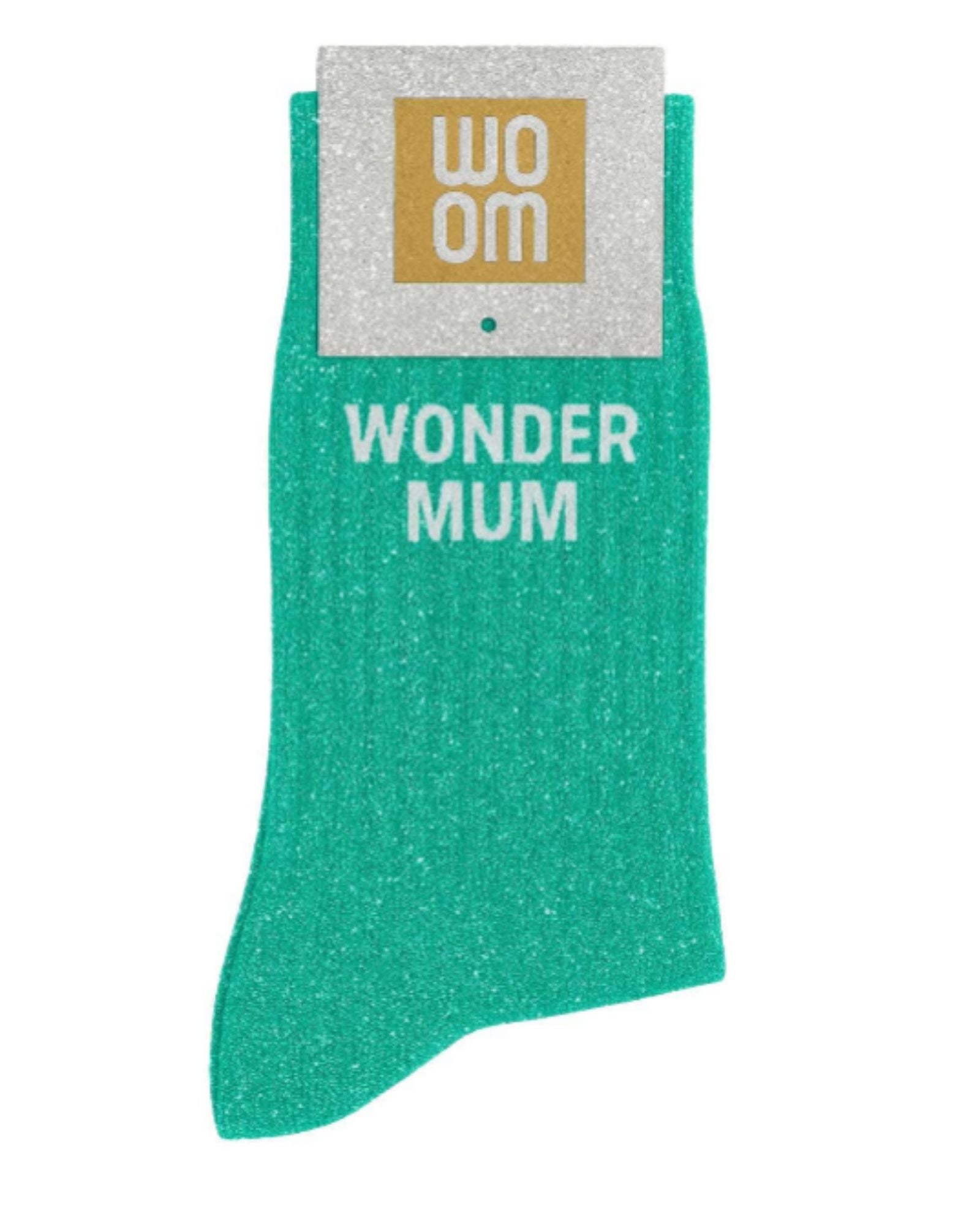 Almond green glitter message socks with a white jacquard WONDER MUM inscription at the ankle, presented in their original Woom paper packaging.