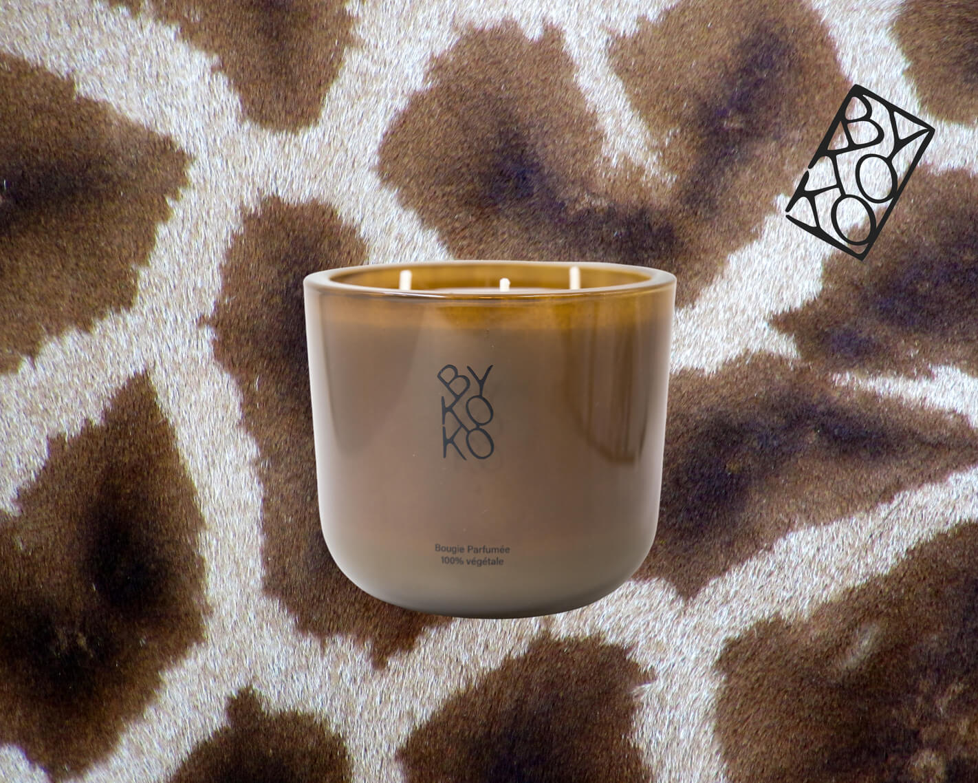 BYKOKO - HAVANA LOVERS candle in elegant taupe glass container, crafted in Geneva, exuding a captivating fragrance of amber, vanilla & zesty orange