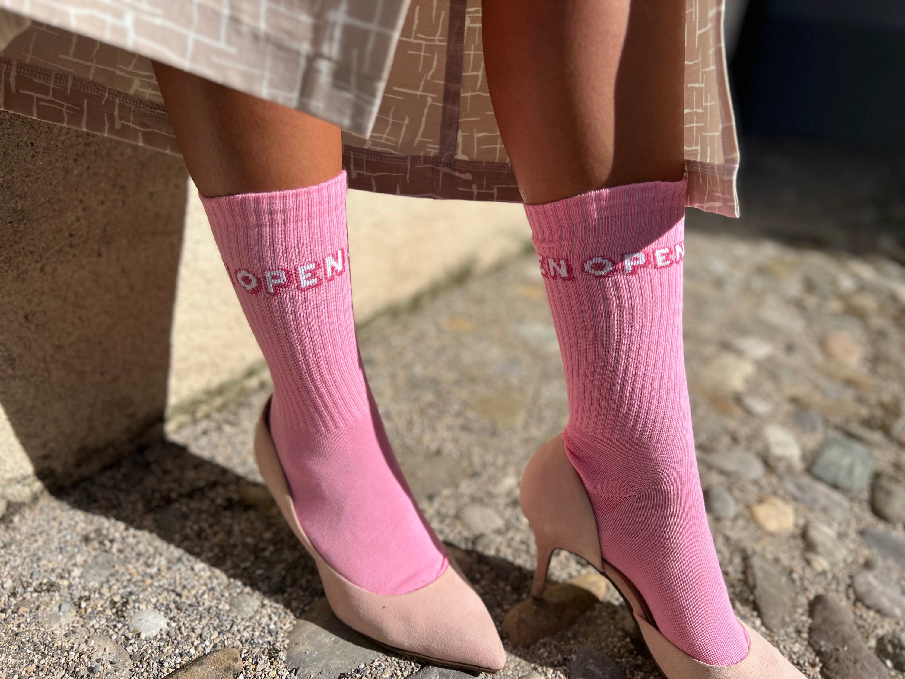 a woman wearing pink organic cottons socks by Chaton Gonflable and high heels
