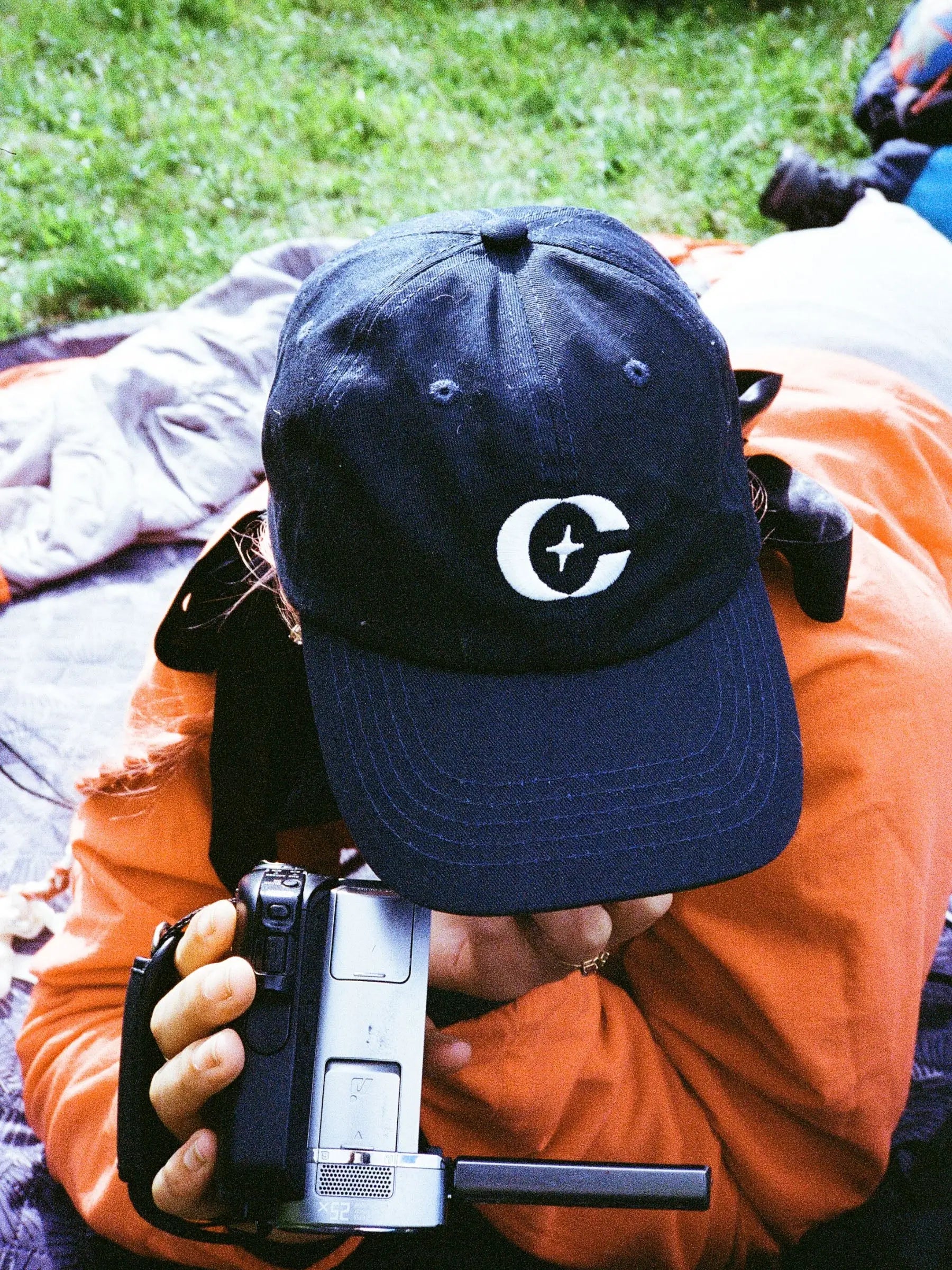 a person wearing a hat and holding a camera