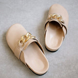 ALOHAS nude leather clogs shown as a pair, with gold chain-link trim across the front strap.