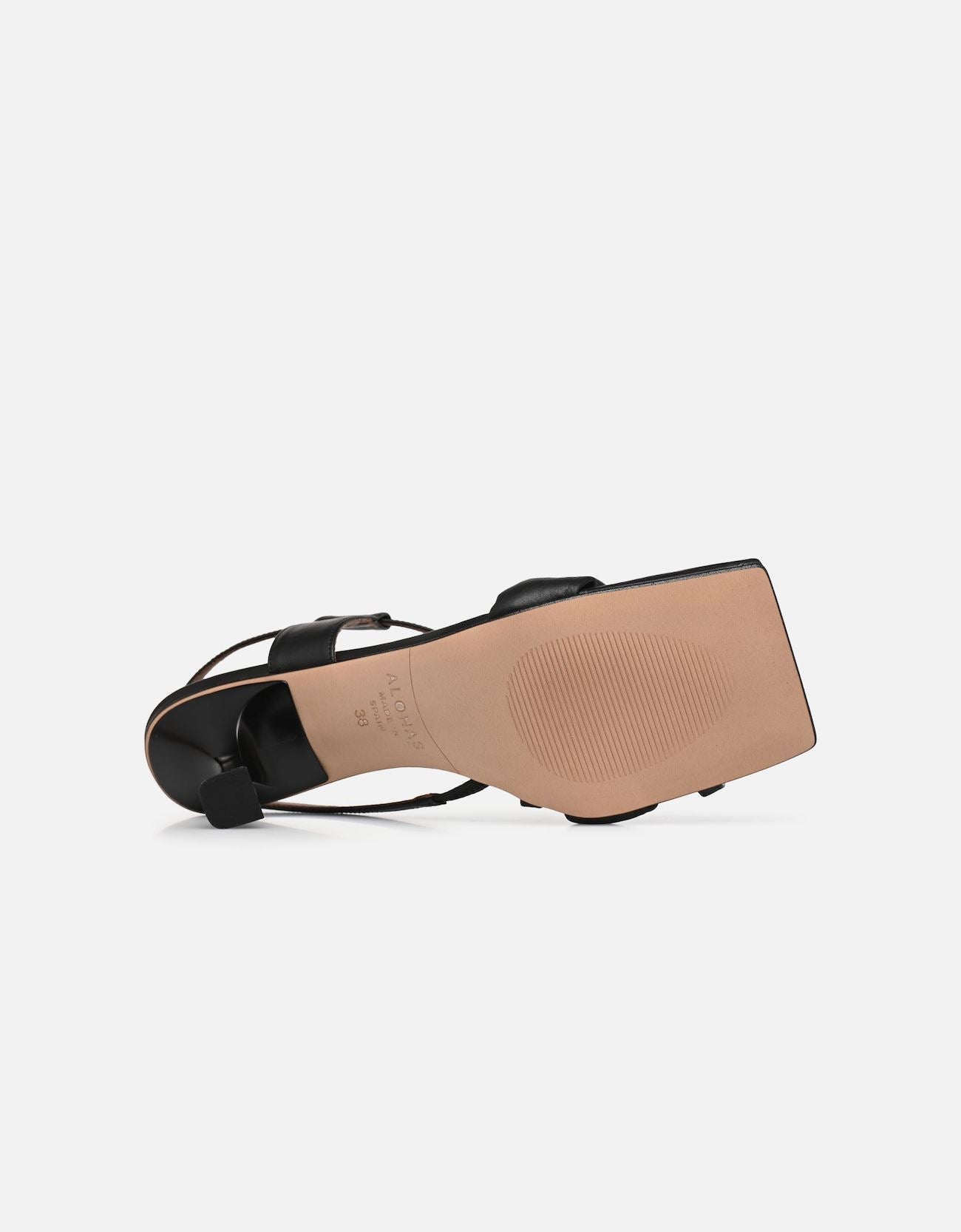 Underside view of the ALOHAS black square-toe slingback heels, showing the tan sole and sculpted heel.
