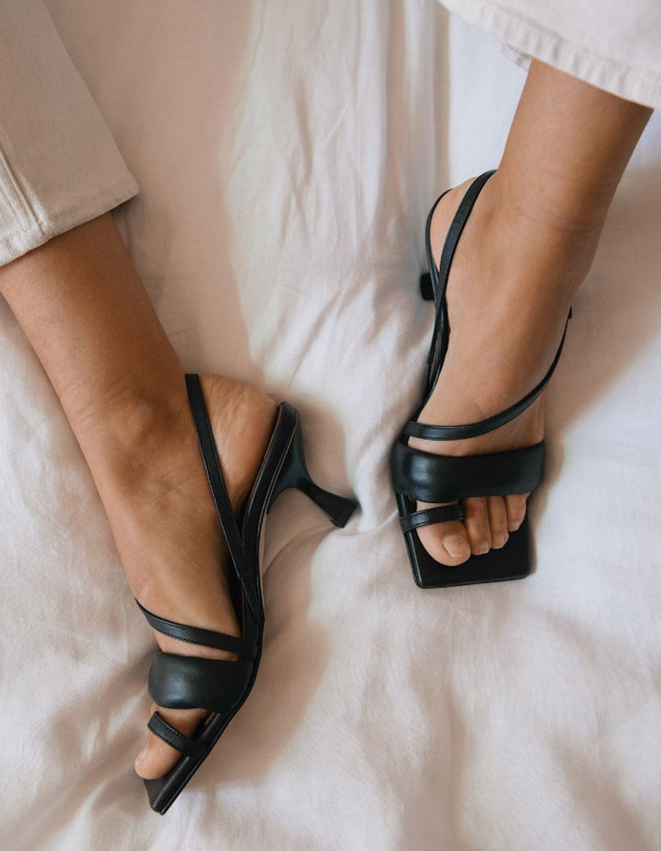 Woman wearing the ALOHAS black square-toe slingback heels.