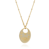 Azuni Astral All Seeing Eye necklace, a gold-tone oval pendant engraved with an eye and stars on a beaded chain.