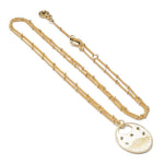 Azuni Astral All Seeing Eye pendant on a gold beaded chain, shown coiled on a white background.