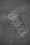 a close up view of a the woven logo of French sustainable fashion brand DOXA