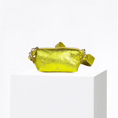Craie Studio Doudoune belt bag in yellow metallic bubble leather with an adjustable strap, on a plinth.