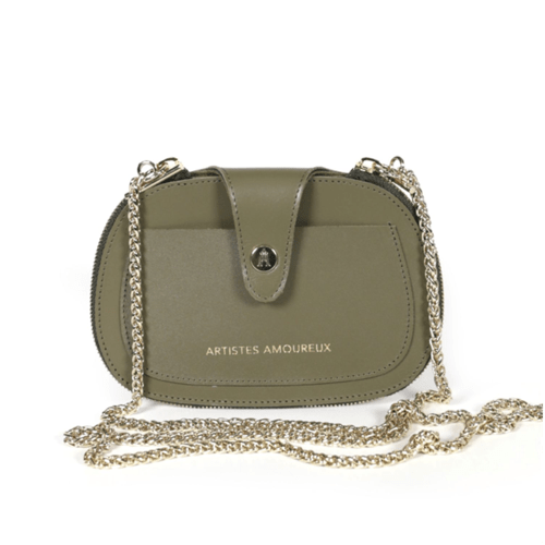 Craie Studio Essentiel kaki leather camera bag with a detachable gold chain strap, on a plinth.