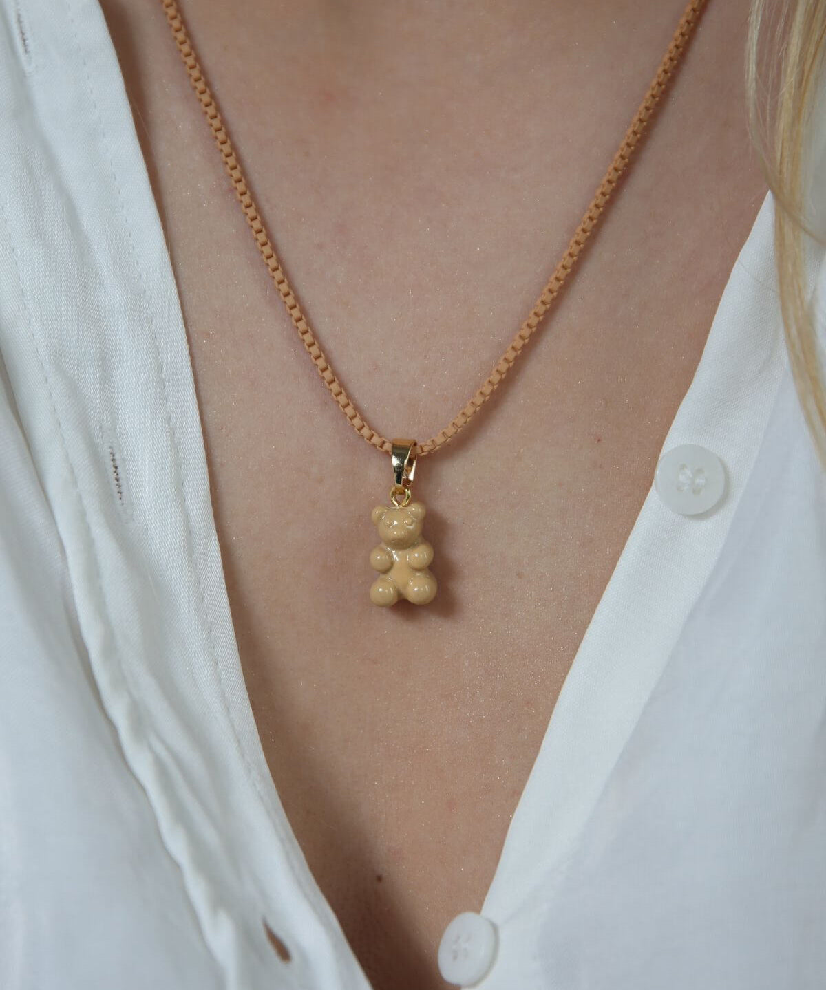 Crystal Haze caramel Nostalgia Bear pendant worn on a matching caramel cord necklace.