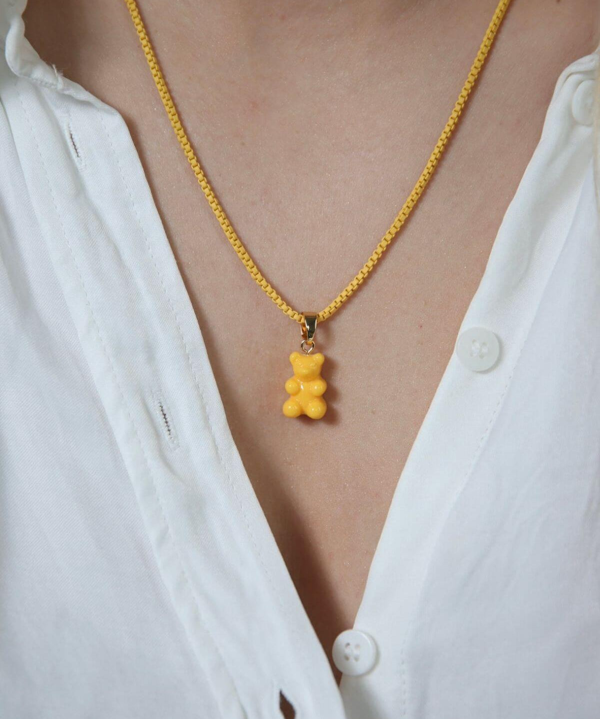 Crystal Haze yellow Nostalgia Bear pendant worn on a fine gold chain necklace