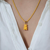 Crystal Haze yellow Nostalgia Bear pendant worn on a fine gold chain necklace