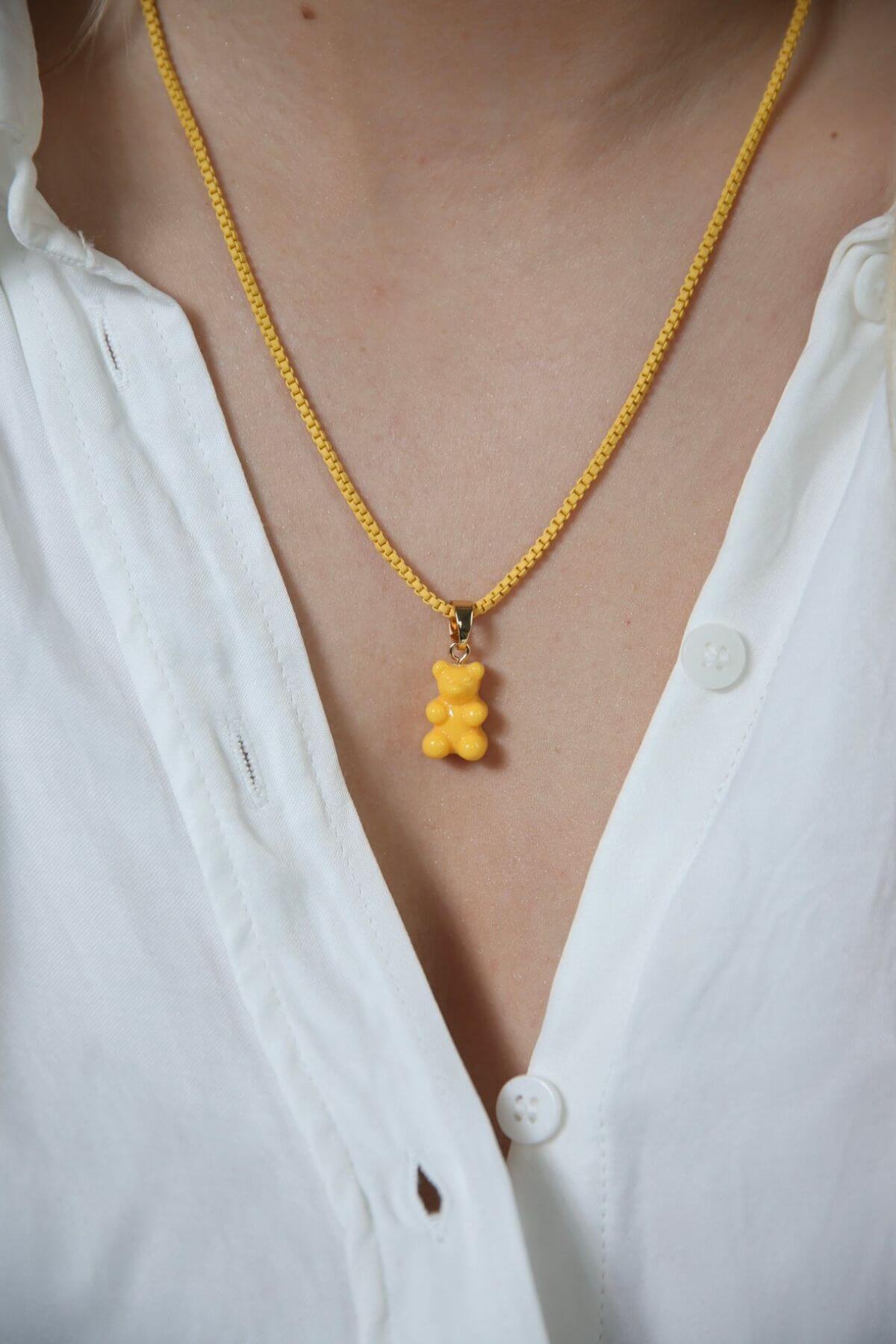 Crystal Haze yellow Nostalgia Bear pendant worn on a fine gold chain necklace