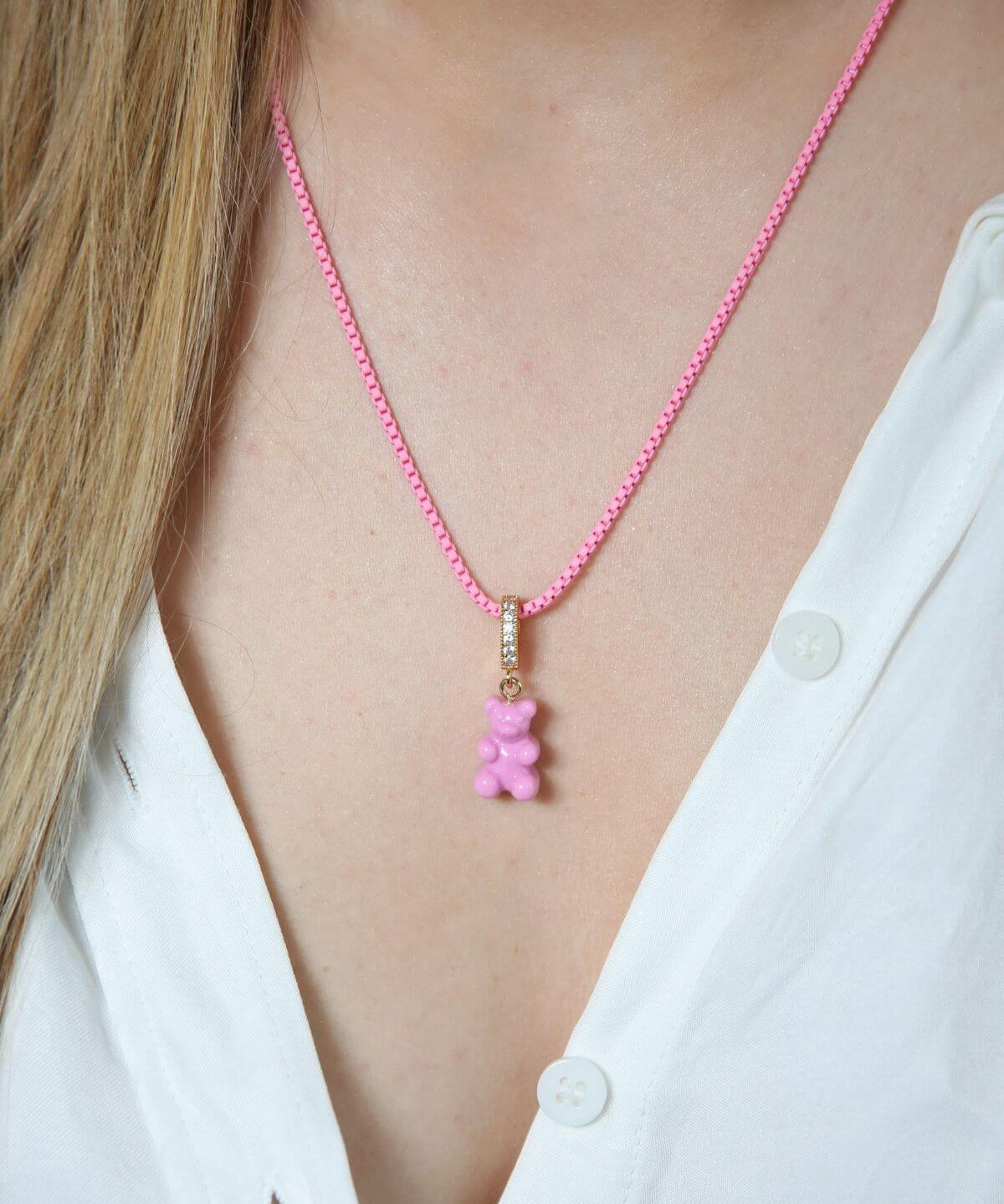 Crystal Haze candy pink Nostalgia Bear pendant worn on a pink cord necklace, resting at the collarbone.