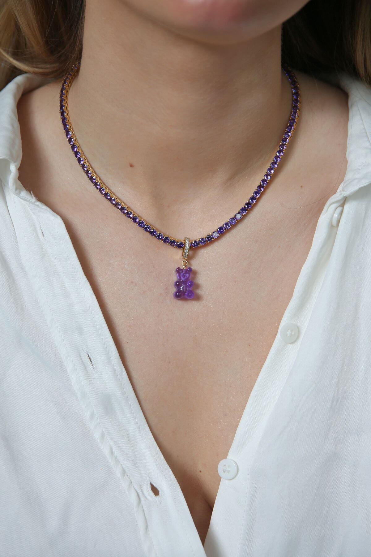 Crystal Haze purple Nostalgia Bear pendant worn on a necklace, resting at the collarbone.
