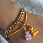Crystal Haze yellow Nostalgia Bear charm shown stacked with a lavender charm on gold bracelets
