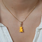Crystal Haze yellow Nostalgia Bear pendant worn on a fine gold chain necklace