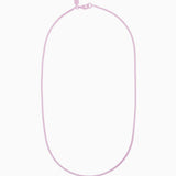 Crystal Haze Plastalina necklace in lavender enamel, flat lay on a white background