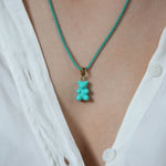 Crystal Haze Plastalina necklace in turquoise enamel, worn with a matching teal Nostalgia Bear charm
