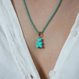 Crystal Haze Plastalina necklace in turquoise enamel, worn with a matching teal Nostalgia Bear charm
