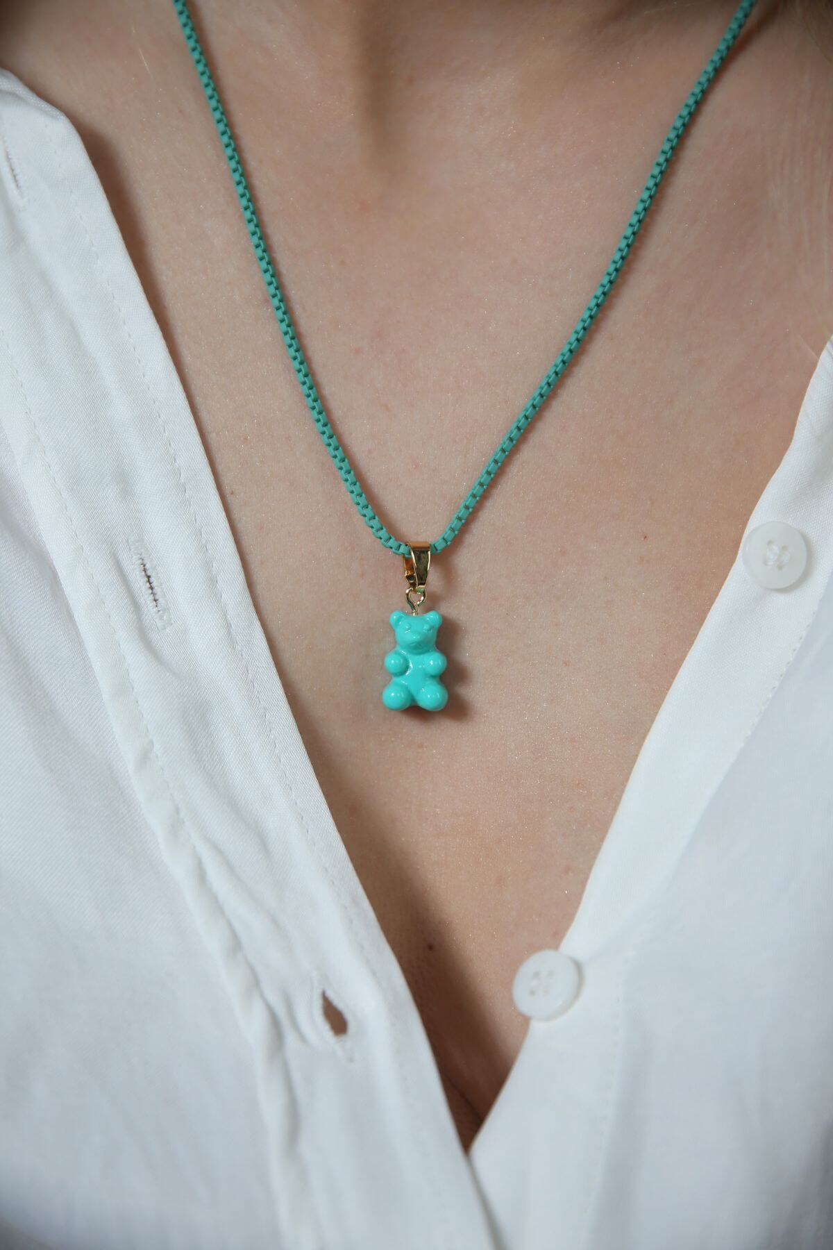Crystal Haze Plastalina necklace in turquoise enamel, worn with a matching teal Nostalgia Bear charm