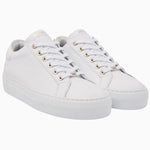 Front angle of the Nubikk Jolie white sneakers, highlighting the gold eyelets and clean leather upper.