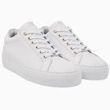 Front angle of the Nubikk Jolie white sneakers, highlighting the gold eyelets and clean leather upper.