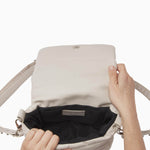 NUBIKK beige May leather bag, interior view showing the zip pocket and lining