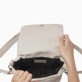 NUBIKK beige May leather bag, interior view showing the zip pocket and lining
