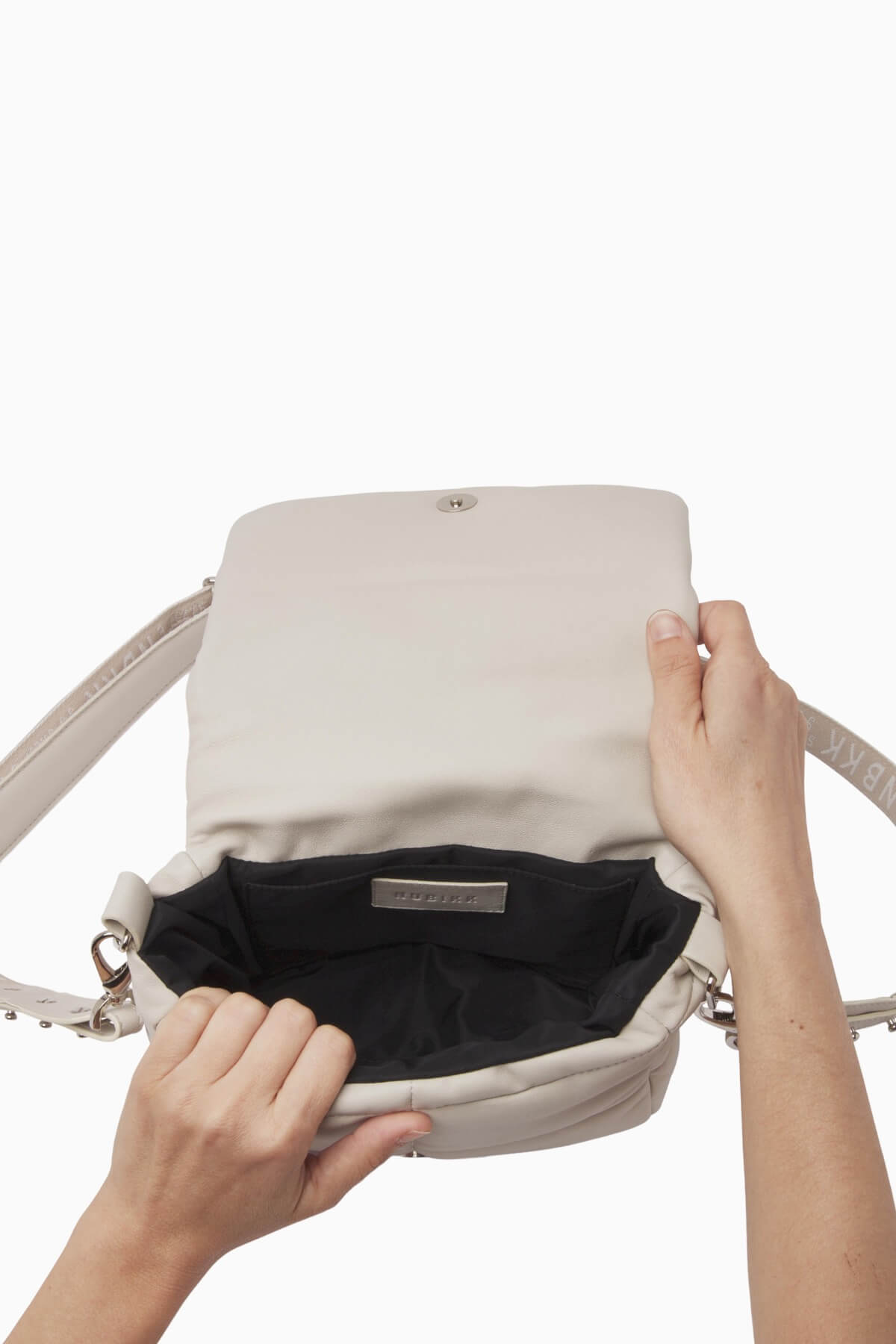 NUBIKK beige May leather bag, interior view showing the zip pocket and lining
