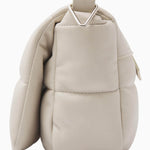 NUBIKK beige May leather bag, side profile flat lay showing the quilted panel stitching