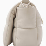 NUBIKK beige May leather bag, side profile flat lay showing the quilted panel stitching
