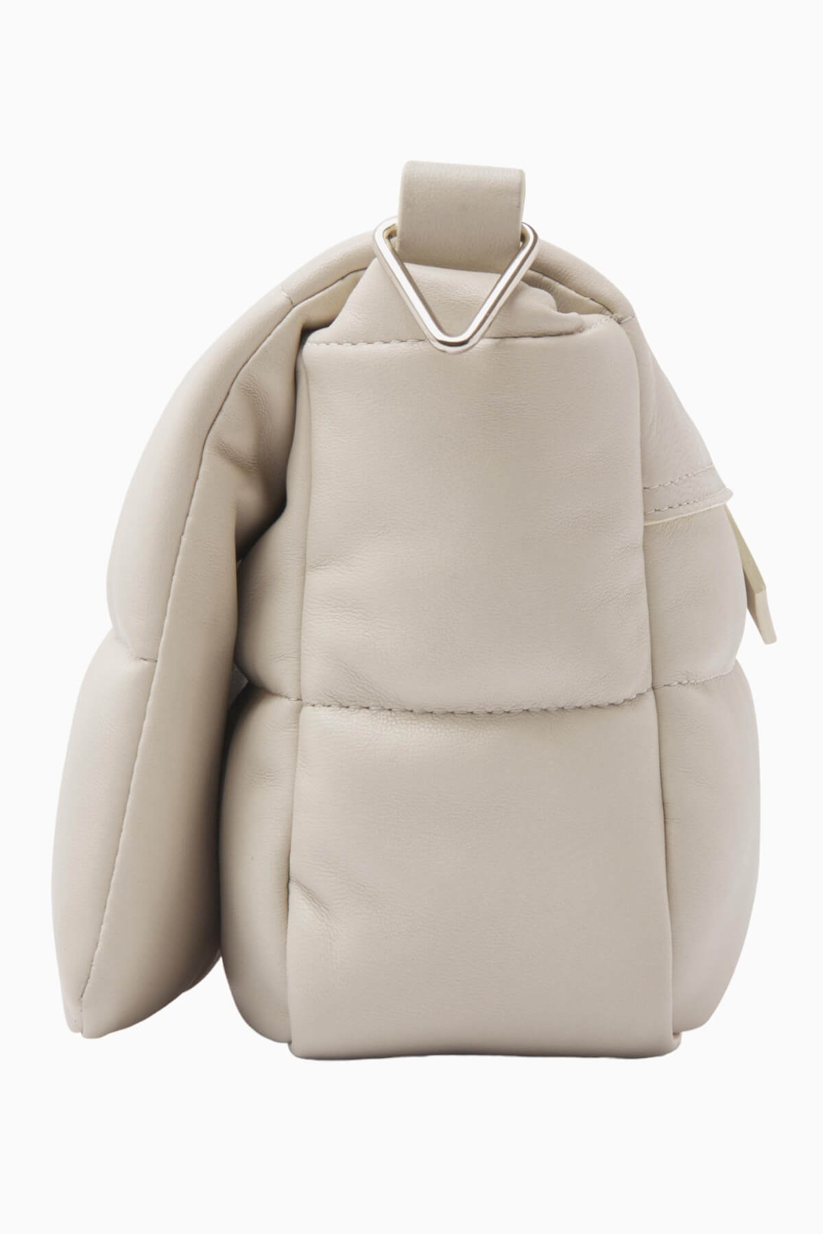 NUBIKK beige May leather bag, side profile flat lay showing the quilted panel stitching