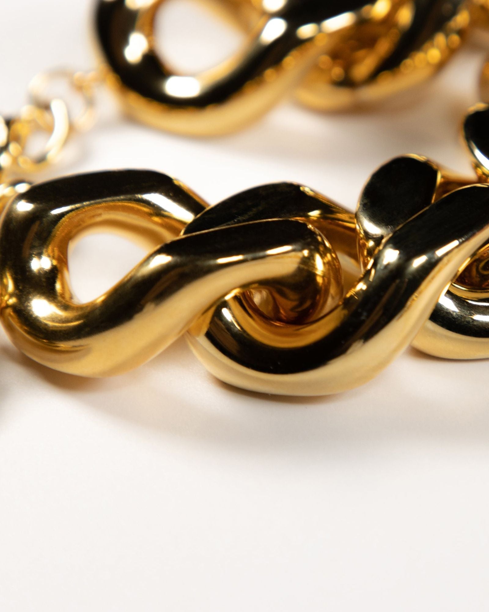 Close-up of the gold flat chain bracelet by Vanessa Baroni featuring oversized acetate links